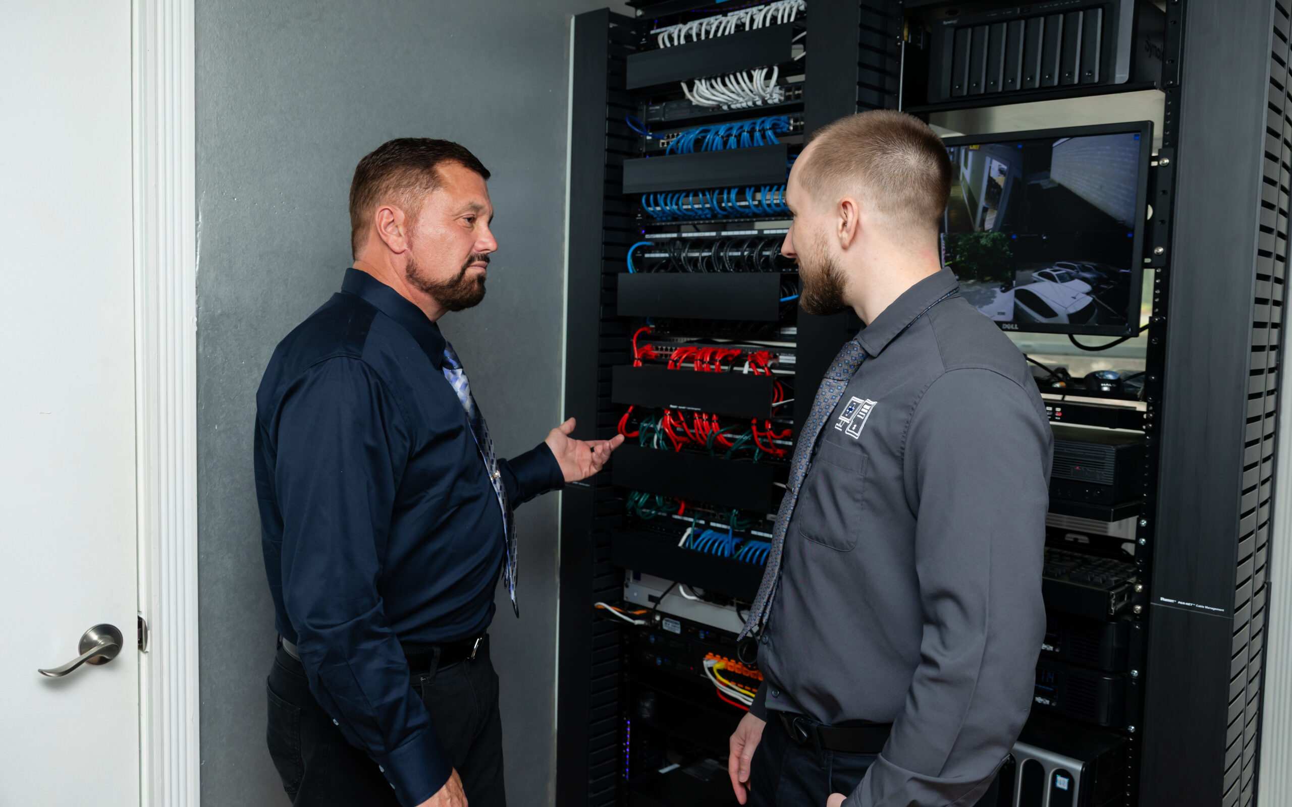 Two men discuss a server.