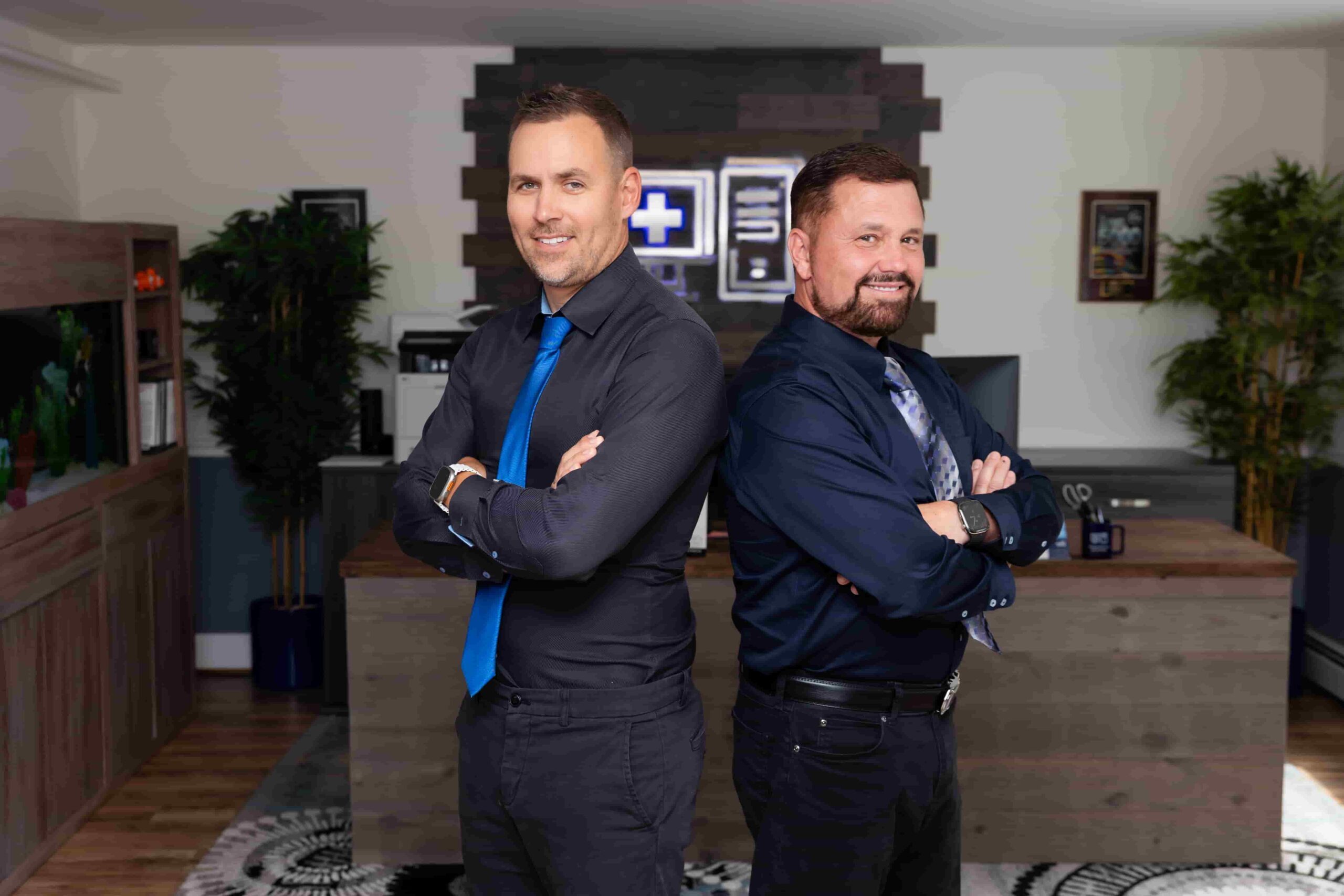 The owners of IT Support RI standing back to back