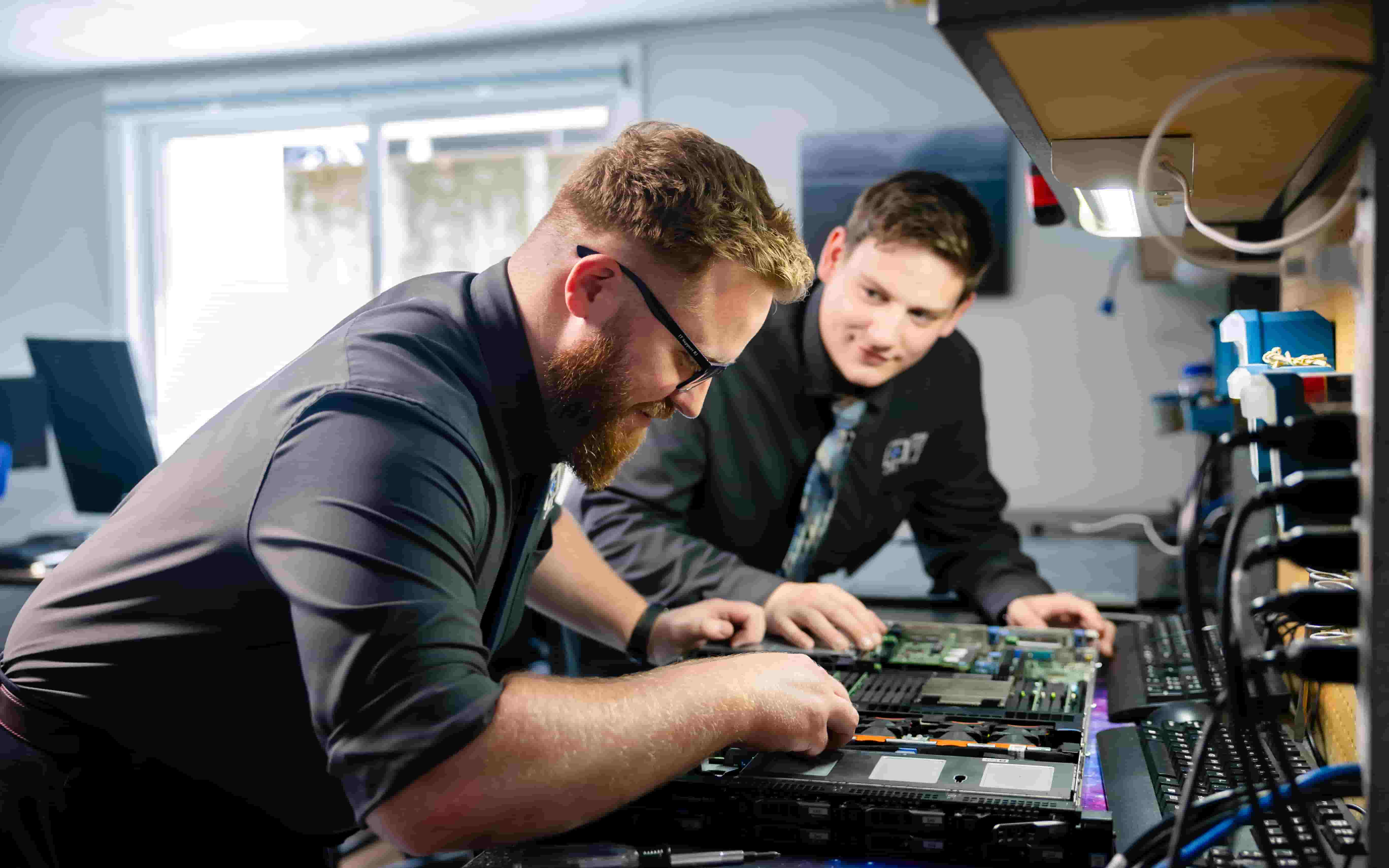 Connor and Tucker working on a server together